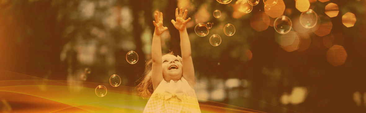 Little Girl Chasing Bubbles
