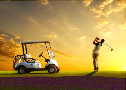 Man Swinging Golf Club next to Golf Cart