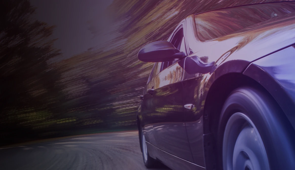 electrified-sedan-driving-down-the-road-image