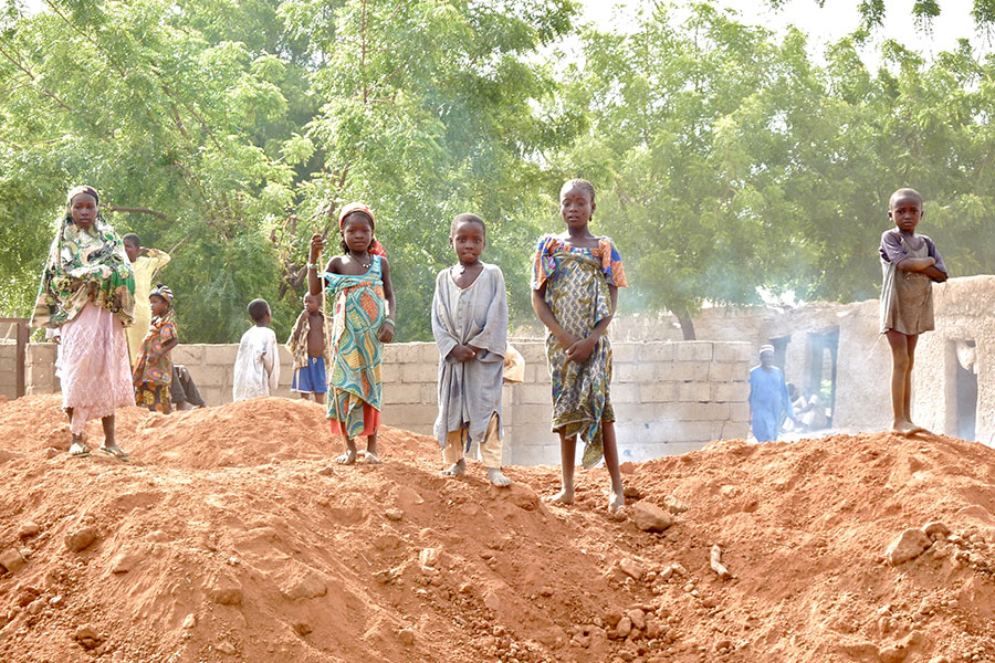 Children Standing on Dirt Piles