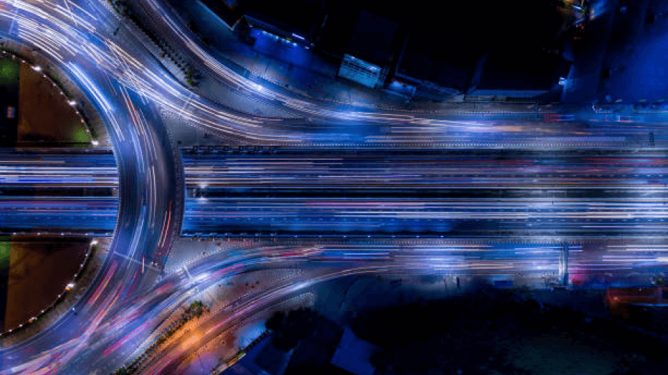 Overhead Lights View of Converging Highways at Night