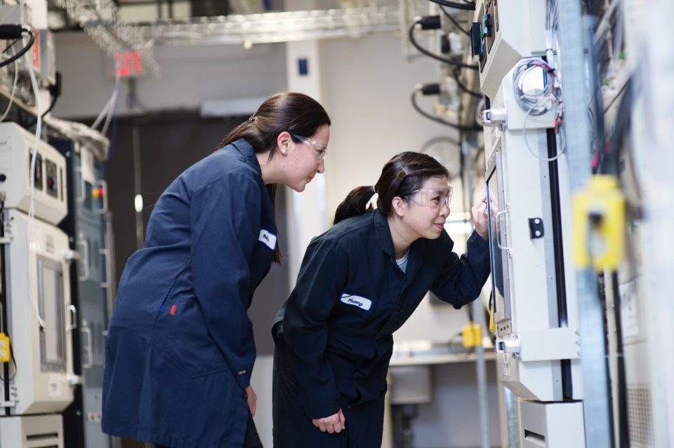 Two Female Plant Workers Checking Gauges