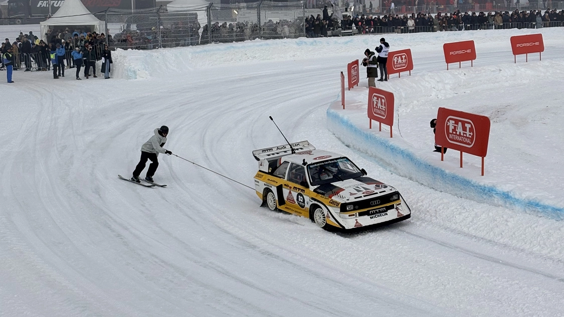 car pulling skier around track