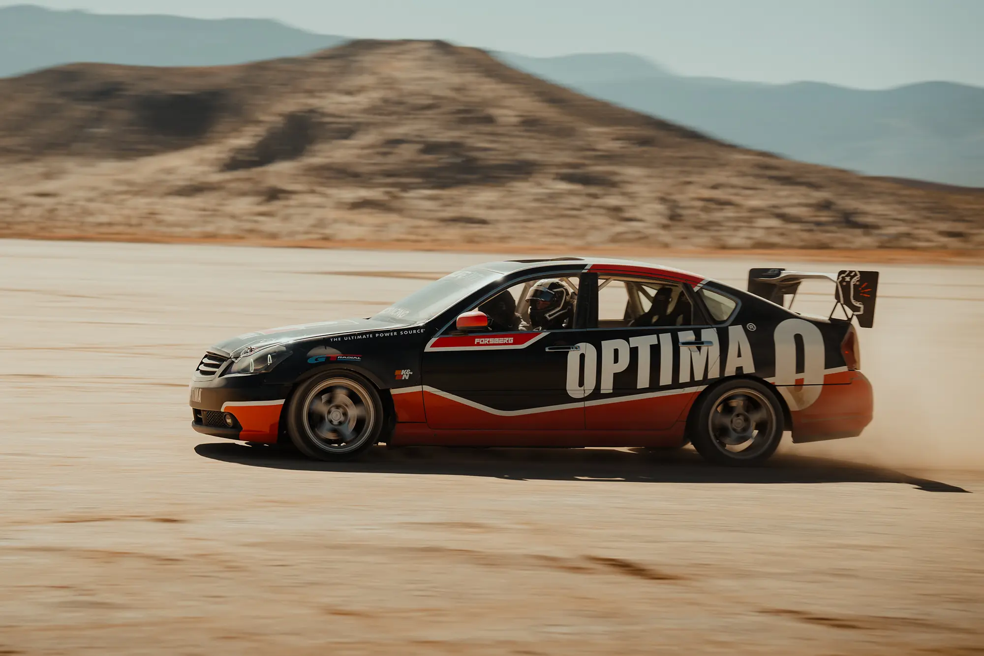 optima car racing through desert