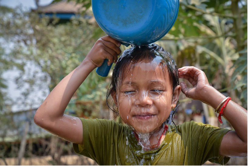 Child dumping clean water over their head