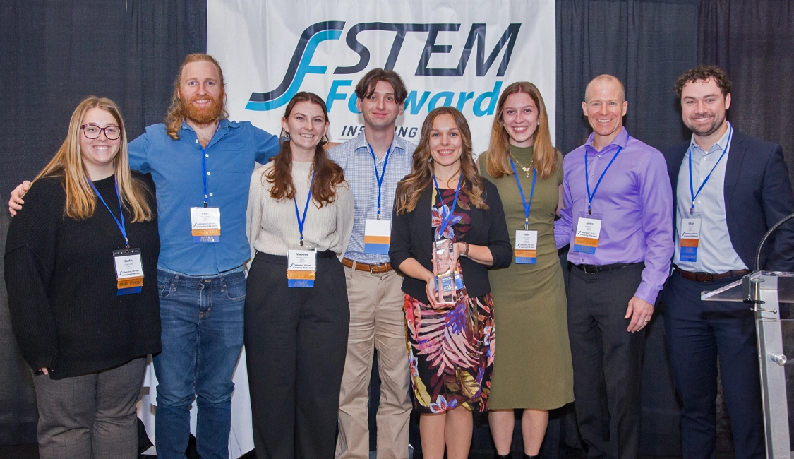 Clarios team receiving stem award on stage