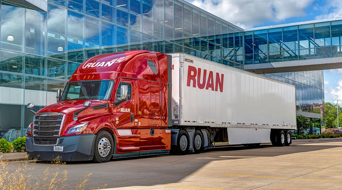 ruan semi truck in front of building